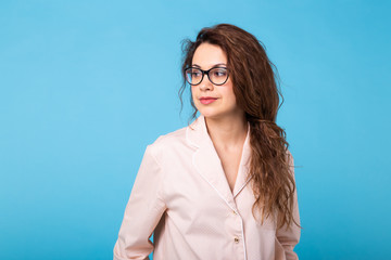 Young girl posing in pajamas on blue background. Relax good mood, lifestyle and sleepwear concept.