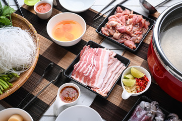 Sukiyaki . Preparation of raw materials,beef,egg ,tofu,vegetable and mung bean noodle  for sukiyaki using hot pots.