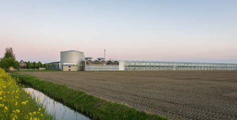 Obraz premium Modern complex of greenhouses and heating house in western part of The Netherlands