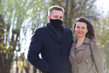 Masked couple walking in the park