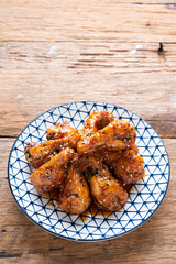 Sour-sweet baked chicken wings sesame and  teriyaki sauce.
