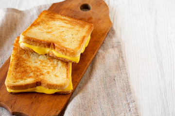 Homemade Grilled Cheese Sandwich on a rustic wooden board, low angle view. Copy space.