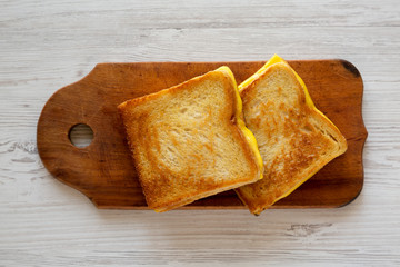 Homemade Grilled Cheese Sandwich on a rustic wooden board, top view. Overhead, from above, flat lay. Close-up.