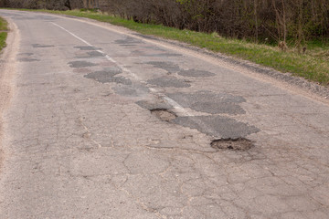 holes in the road, broken asphalt.