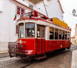 Plakat Typical old tram crowded with tourists crisscrossing Lisbon in Portugal