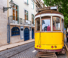 Fototapeta na wymiar Typical old tram crowded with tourists crisscrossing Lisbon in Portugal