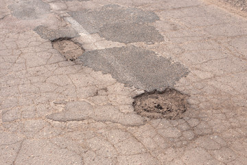 holes and cracks in the asphalt