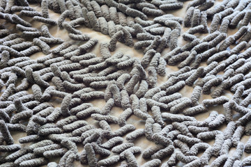 Closeup dirty grey doormat pattern.