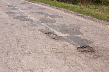 holes in the asphalt. bad road.