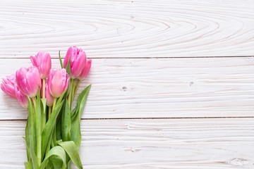 pink tulips on wooden background