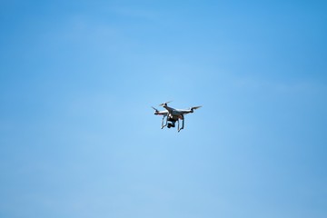 Fototapeta na wymiar White flying drone on a blurry background of nature.
