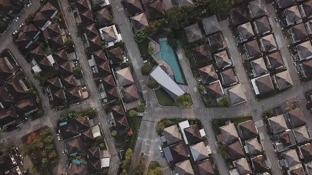 Aerial view of the cottage village with common swimming pool  at sunrise. Similar houses. Koh kaew, Phuket.