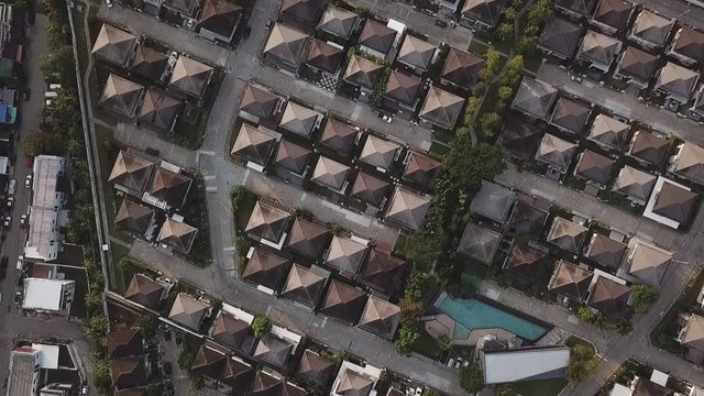 Aerial view of the cottage village with common swimming pool  at sunrise. Similar houses. Koh kaew, Phuket.