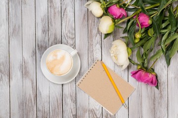 white and pink peonies on a wooden background