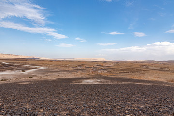 Beautiful mountains with colorful sand. Israel Negev Desert Sede Boker. Great view of the Nakhal Tsin rift. Blue cloudy sky