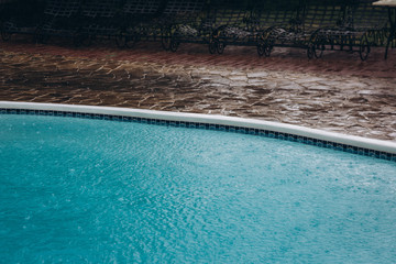 turquoise water in the rain of an empty pool