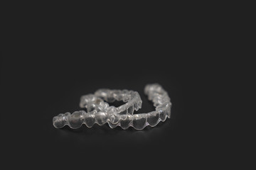 Inivisalign braces, transparent aligner, invisible retainer or orthodontic silicone trainer. A way to have a beautiful smile with teeth model.