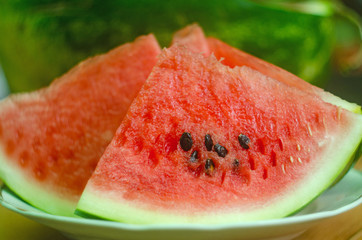 sliced ​​slices of sweet watermelon, background with slices of watermelon