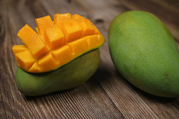 Close up of famous sweet mango in North Malaysia called Harum Manis isolated on top of dark wooden background. Sweet and juicy. Malaysian and Asian favourite mango.