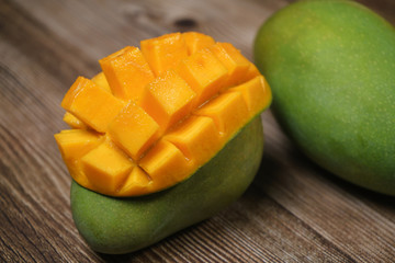 Close up of famous sweet mango in North Malaysia called Harum Manis isolated on top of dark wooden background. Sweet and juicy. Malaysian and Asian favourite mango.