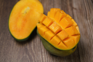 Close up of famous sweet mango in North Malaysia called Harum Manis isolated on top of dark wooden background. Sweet and juicy. Malaysian and Asian favourite mango.