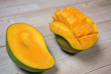Close up of famous sweet mango in North Malaysia called Harum Manis isolated on top of wooden background. Sweet and juicy. Malaysian and Asian favourite mango.