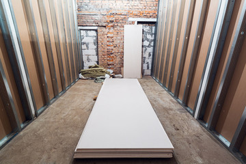 Working process of installing frames for plasterboard - drywall and construction tools in apartment...