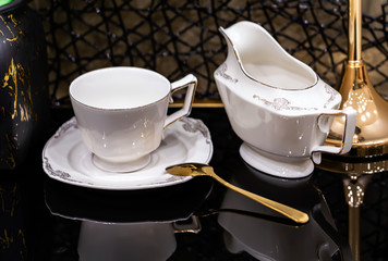selective focus of Elegant white porcelain dinner set on a black glass table.