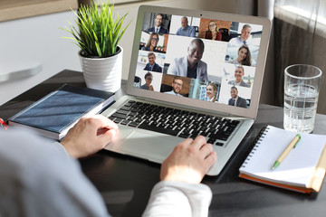 Business woman talking to her colleagues in video conference. Multiethnic business team working...