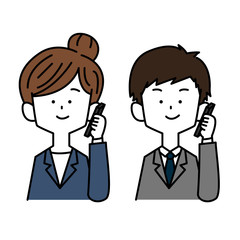スマホで電話をかけるスーツを着た男女