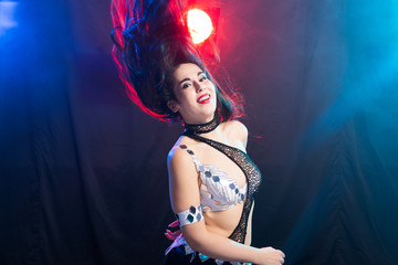 Belly dancer. Young attractive woman dancing tribal fusion on the stage. Oriental exotic dance.