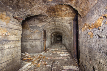Underground abandoned iron ore mine tunnel with concrete timbering
