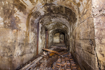 Fototapeta na wymiar Underground abandoned iron ore mine tunnel with concrete timbering