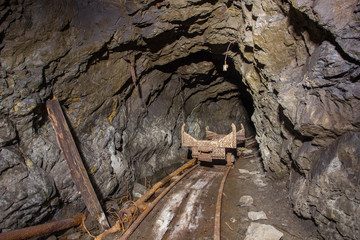 Wagon orecart in underground iron mine tunnel