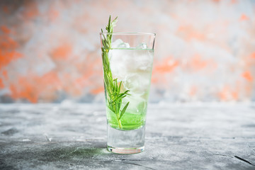 Sweet tequila based green cocktail with tarragon and rosemary. Selective focus. Shallow depth of field.