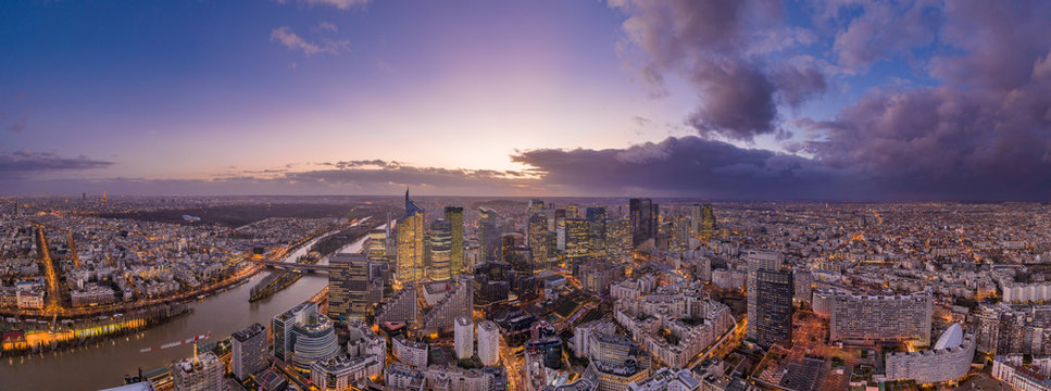 Panoramic aerial drone shot of Neuilly Levallois la defense skyscraper complex with Eiffel tower la seine during sunset hour in Paris