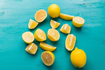 Freshly cut half and whole lemons on rustic aquamarine colour boards. Summer, vitamins and...
