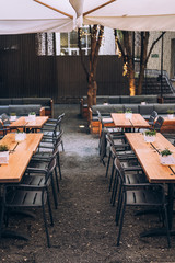 September 2019. Munich. Germany. Deserted summer cafe with wooden tables and metal chairs, Food service. Cafe. A restaurant