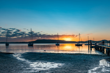 Fototapeta premium Boats and a Bay Sunrise Waterscape