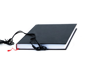 Black headphones and a book isolated on white background. Audiobook concept copy space.