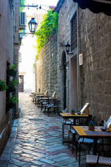 Street cafe on a narrow street in the old town of Kotor, Montenegro