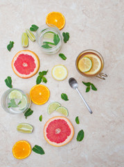 detox beverage concept: the and infused water with lime,grapefruit,citrus,lemon and mint on marble background