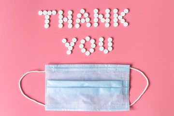 International's nurses day, week concept, Text Thank you by tablets and red heart on pink background.