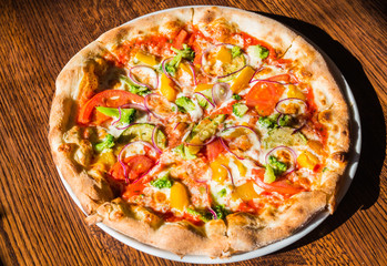 Hot fresh vegetarian pizza on the table. Italian cuisine and dishes concept.