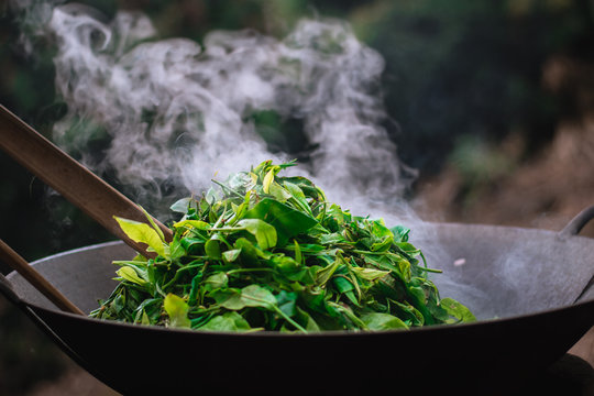 Traditional tea roasting using sticks and hands