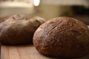 A fresh crusty loaf of homemade bread. Homemade rustic sour bread on a wooden chopping board.
Brown bread