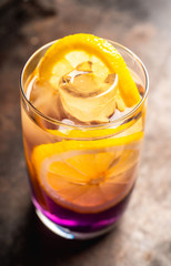 Gin based colorful cocktail with lemon and lavender liqueur on the rustic background. Selective focus. Shallow depth of field.
