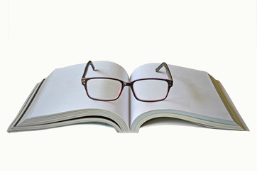 Open thick book and eye glasses on white background