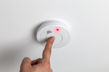Testing home smoke alarm detector. Stay home safe. Home control and security.  Smoke detector