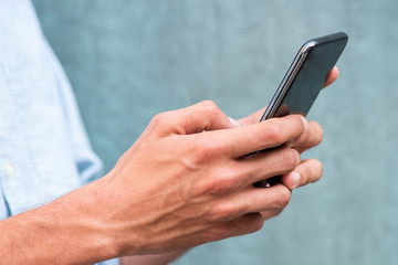 Close up side caucasian man hands holding cellphone